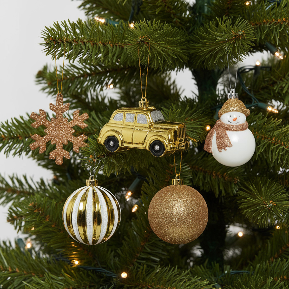 Gold Christmas ornaments: snowflake, car, snowman, baubles