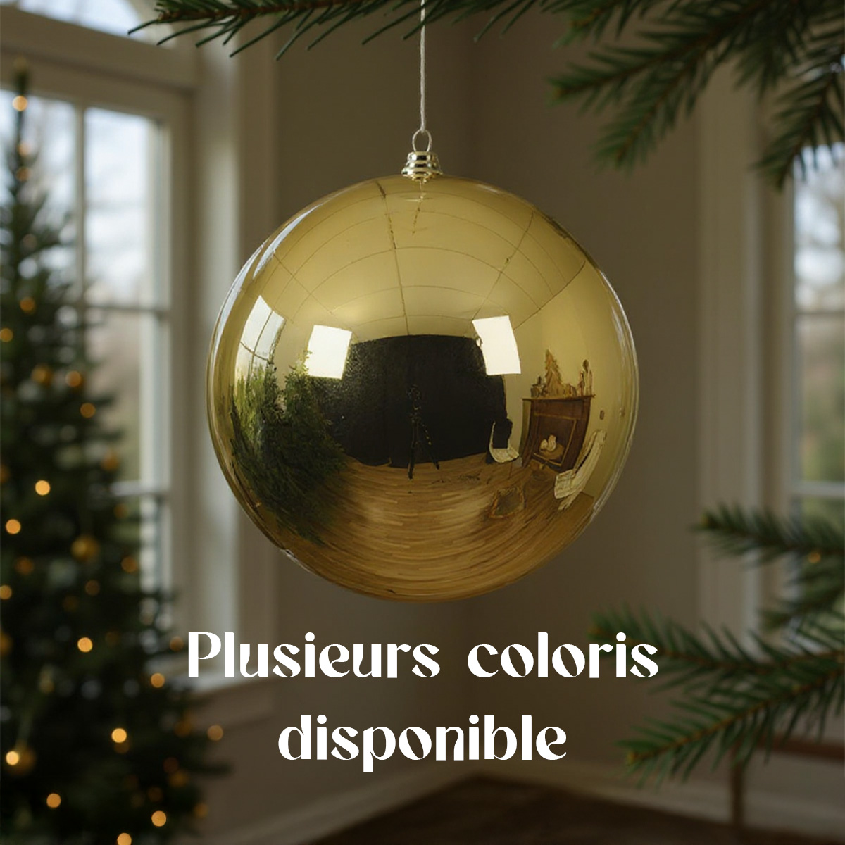 Boule de Noël dorée suspendue devant un sapin et une fenêtre