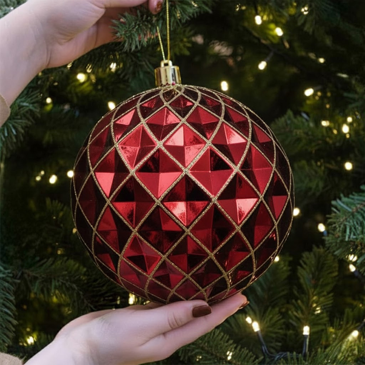 Red and gold Christmas bauble on a decorated tree
