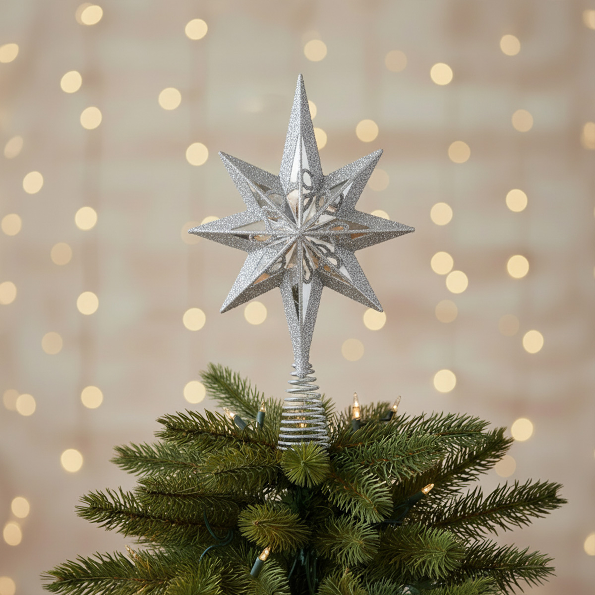 Pointe d'arbre de Noël en étoile argentée scintillante