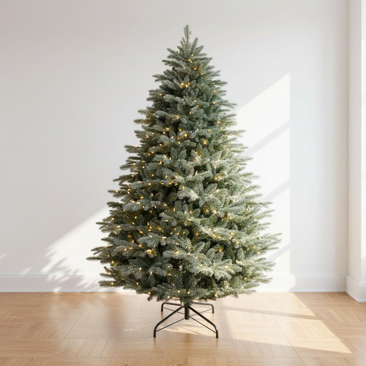 Sapin de Noël artificiel décoré de lumières chaudes sur fond blanc