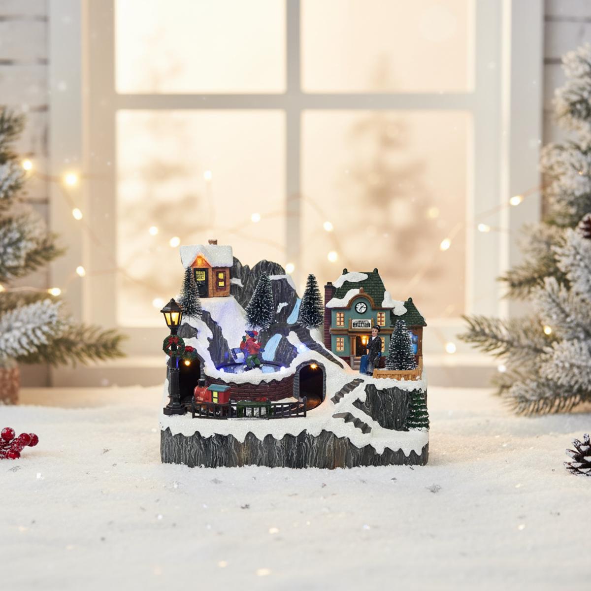 Village de Noël enneigé avec train, patinoire et gare