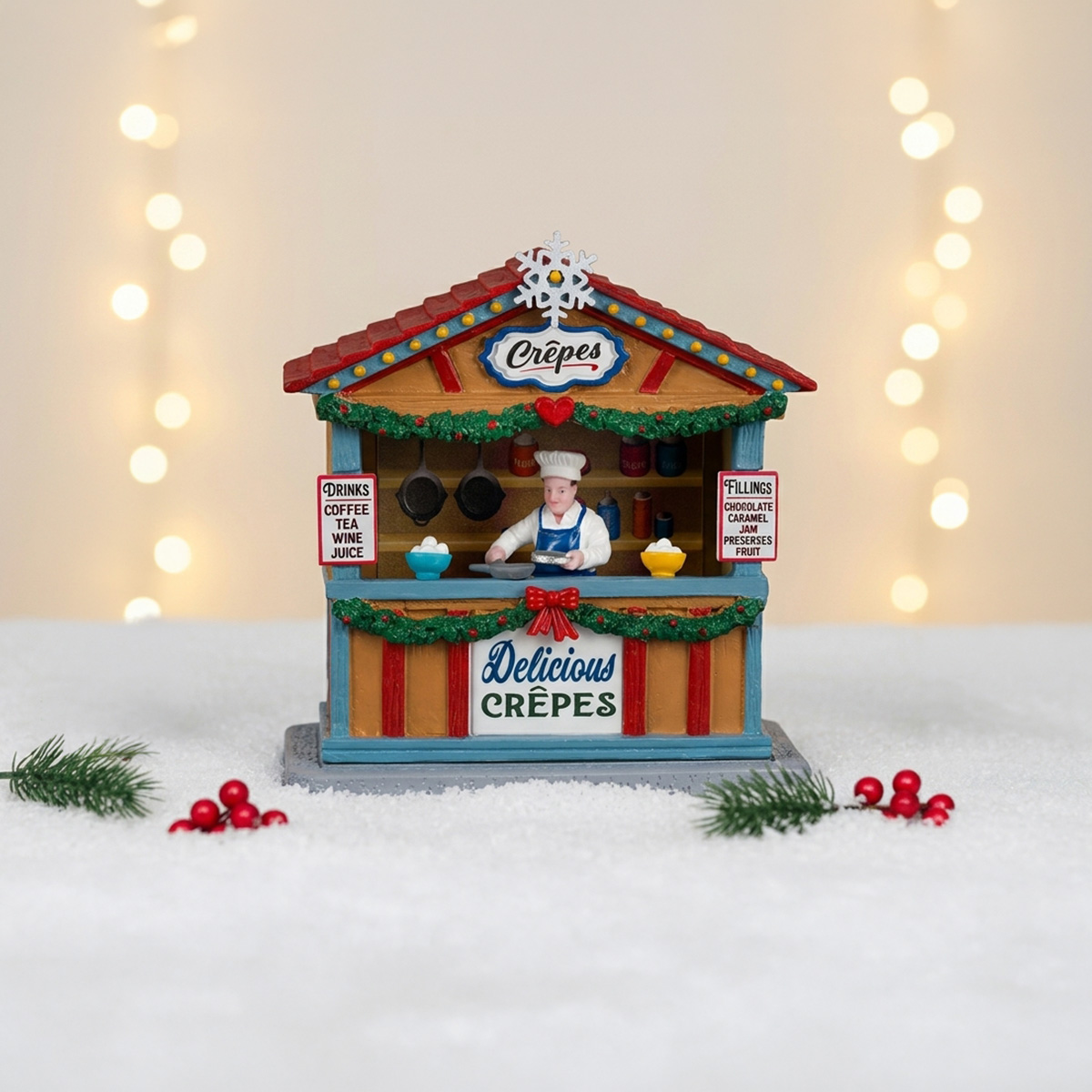 Crêperie miniature de Noël avec un chef, des guirlandes et des lumières