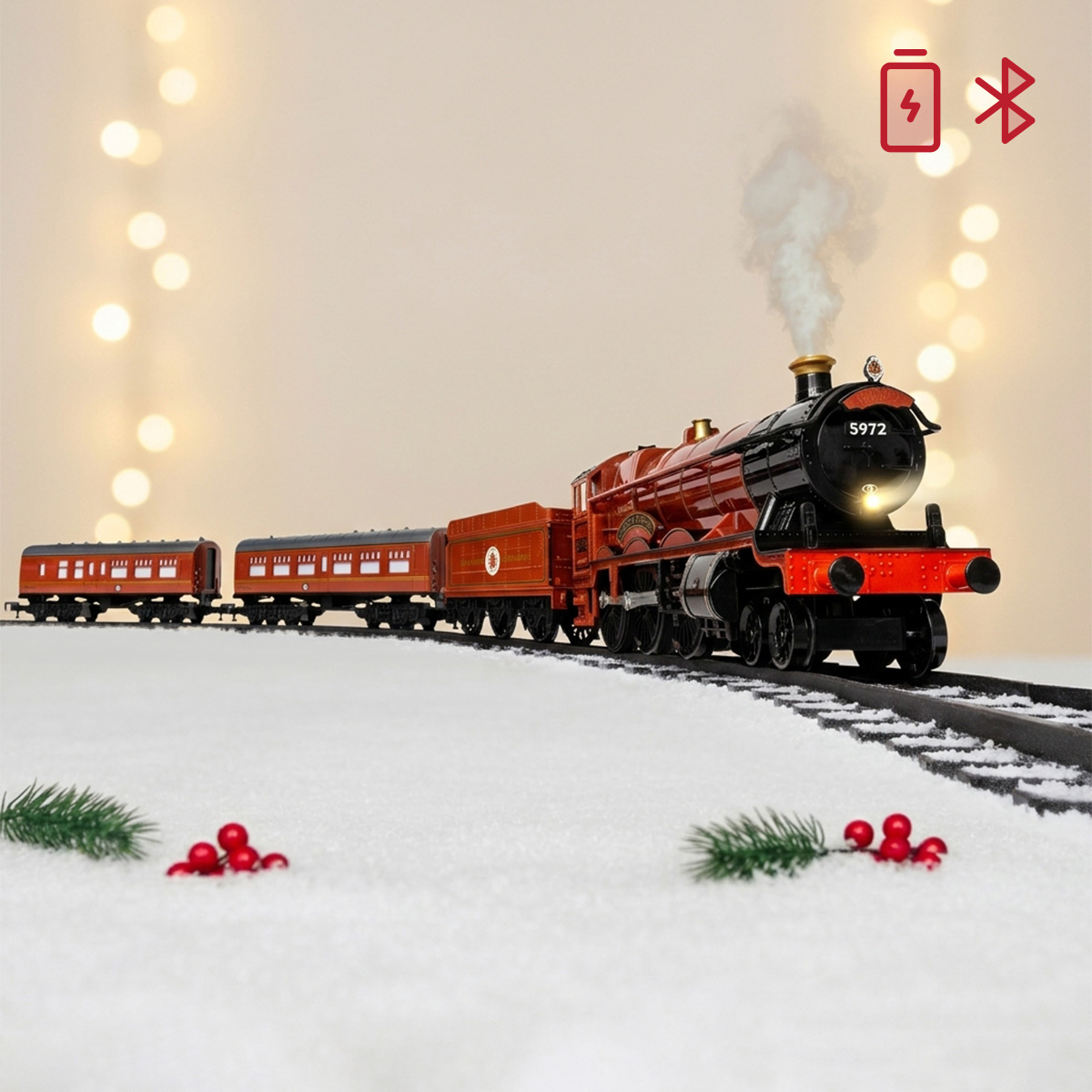 Train Poudlard rouge sur rails enneigés avec lumières de Noël